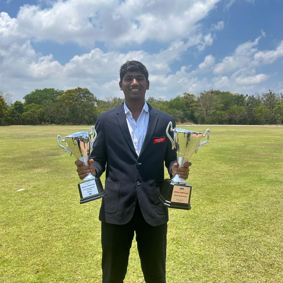 Raghav Nallaperumal with sports trophies showcasing leadership achievements